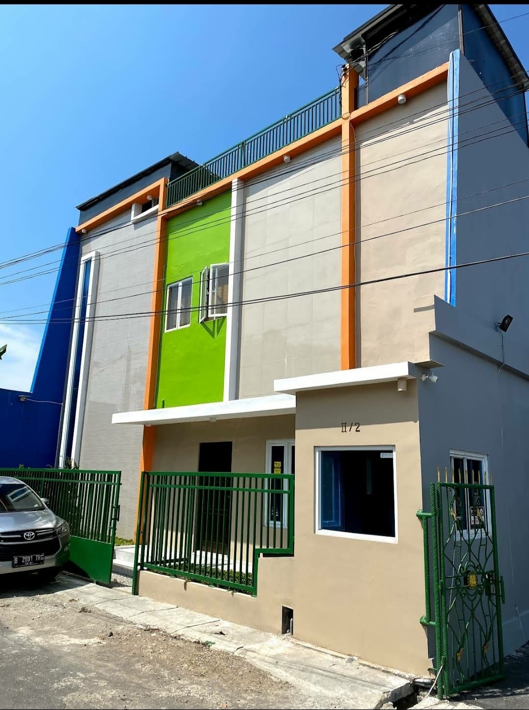 Colorful building with green, orange, and blue sections